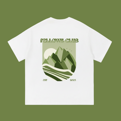 White t-shirt with a mountain graphic and 'Fellows Club' text on a white background